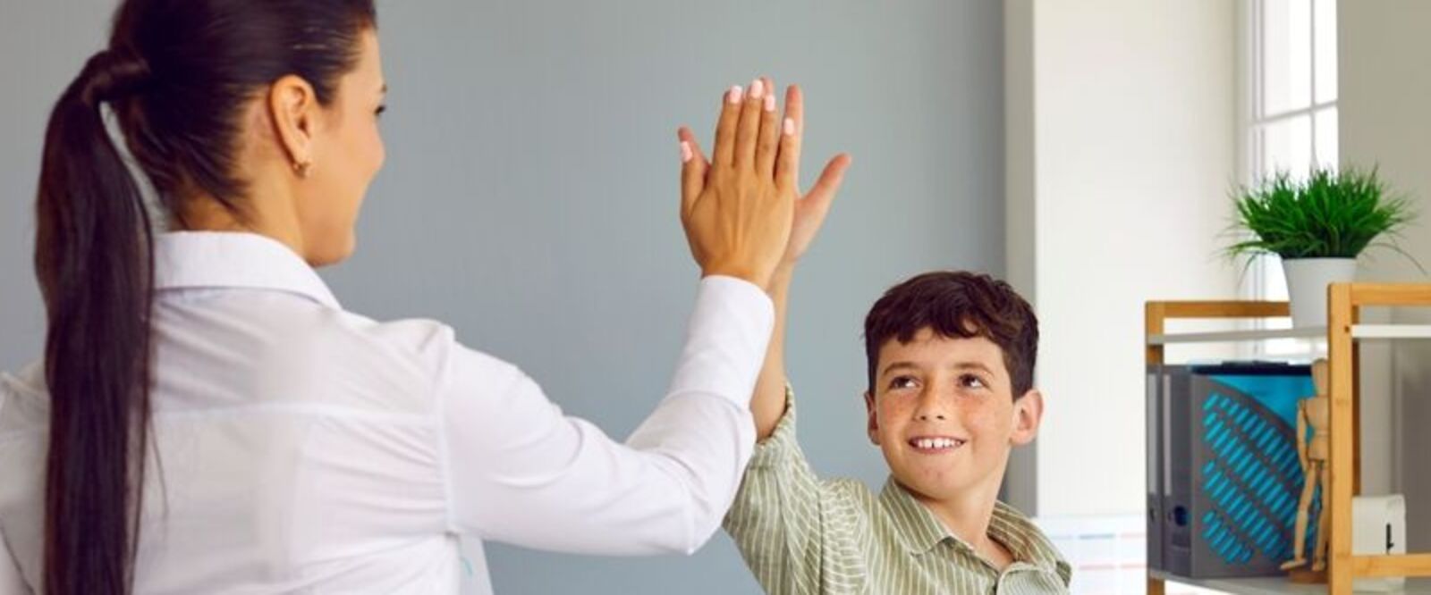 Child high-fiving therapist in Seguin, Texas.
